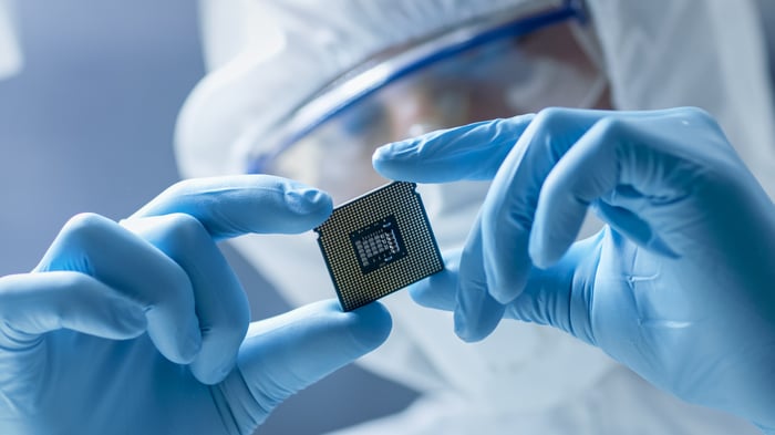 Chip technician holds a microchip. 