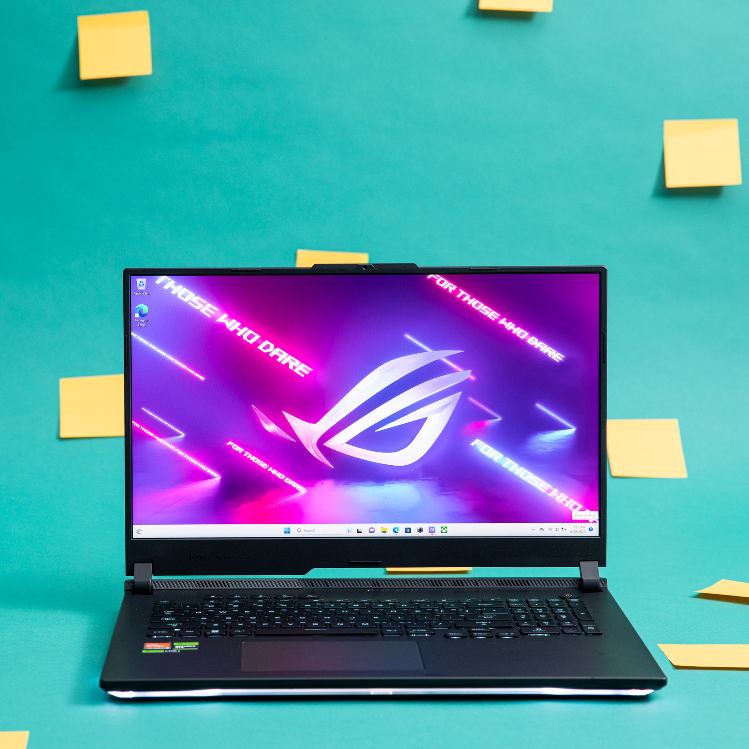 The Asus ROG Strix Scar X3D on a green background decorated with yellow Post-it notes.