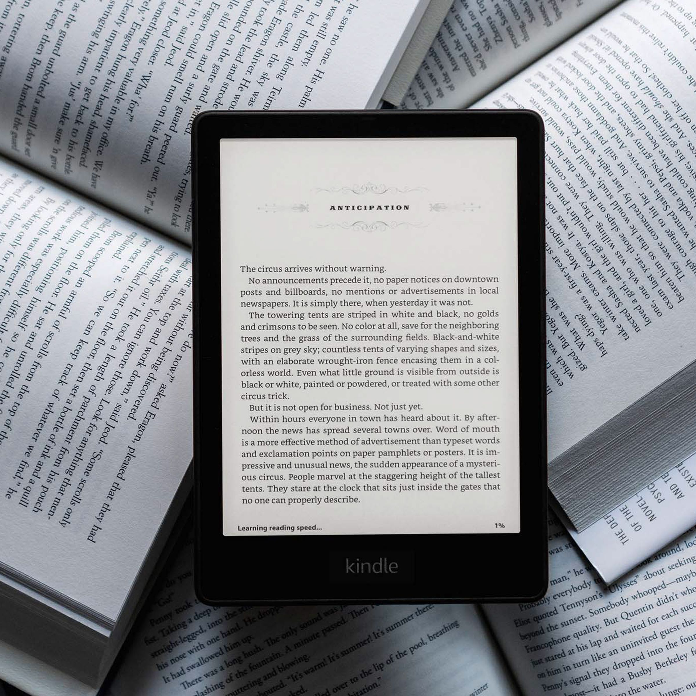 The Kindle Paperwhite against a backdrop of physical books.