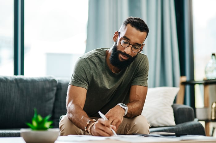 Adult looking at financial paperwork. 